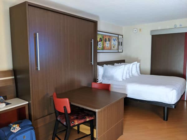 All Star Movies Resort room with bed and table