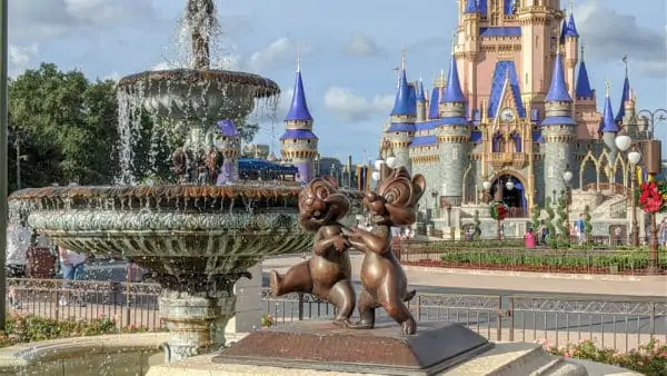 Chip and Dale statue in foreground, fountain and Cinderella Castle in background