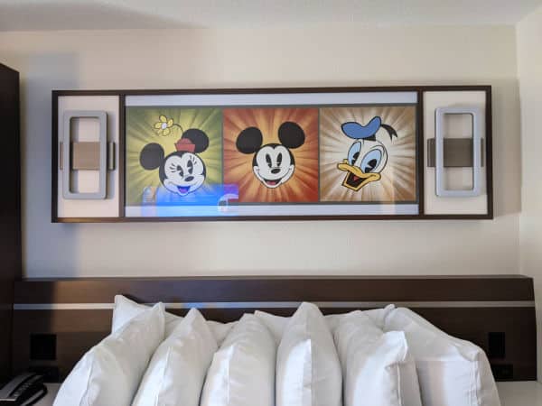Artwork above bed at All Star movies resort features Mickey, Minnie, and Donald