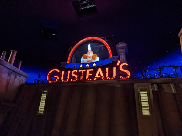 Remy's Ratatouille Adventure interior queue with neon Gusteau's sign