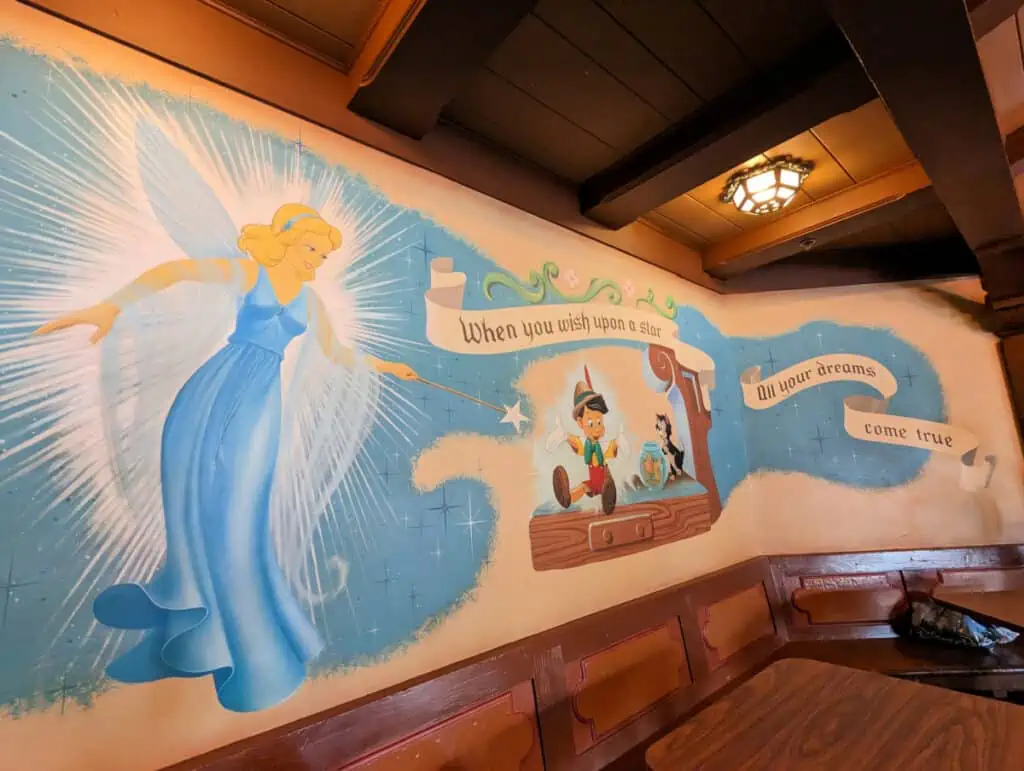 A mural of Pinocchio and the Blue Fairy at Pinocchio Village House in Magic Kingdom.